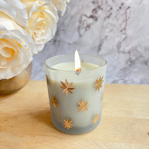 ReStory Scented Candle in a frosted glass jar with gold stars